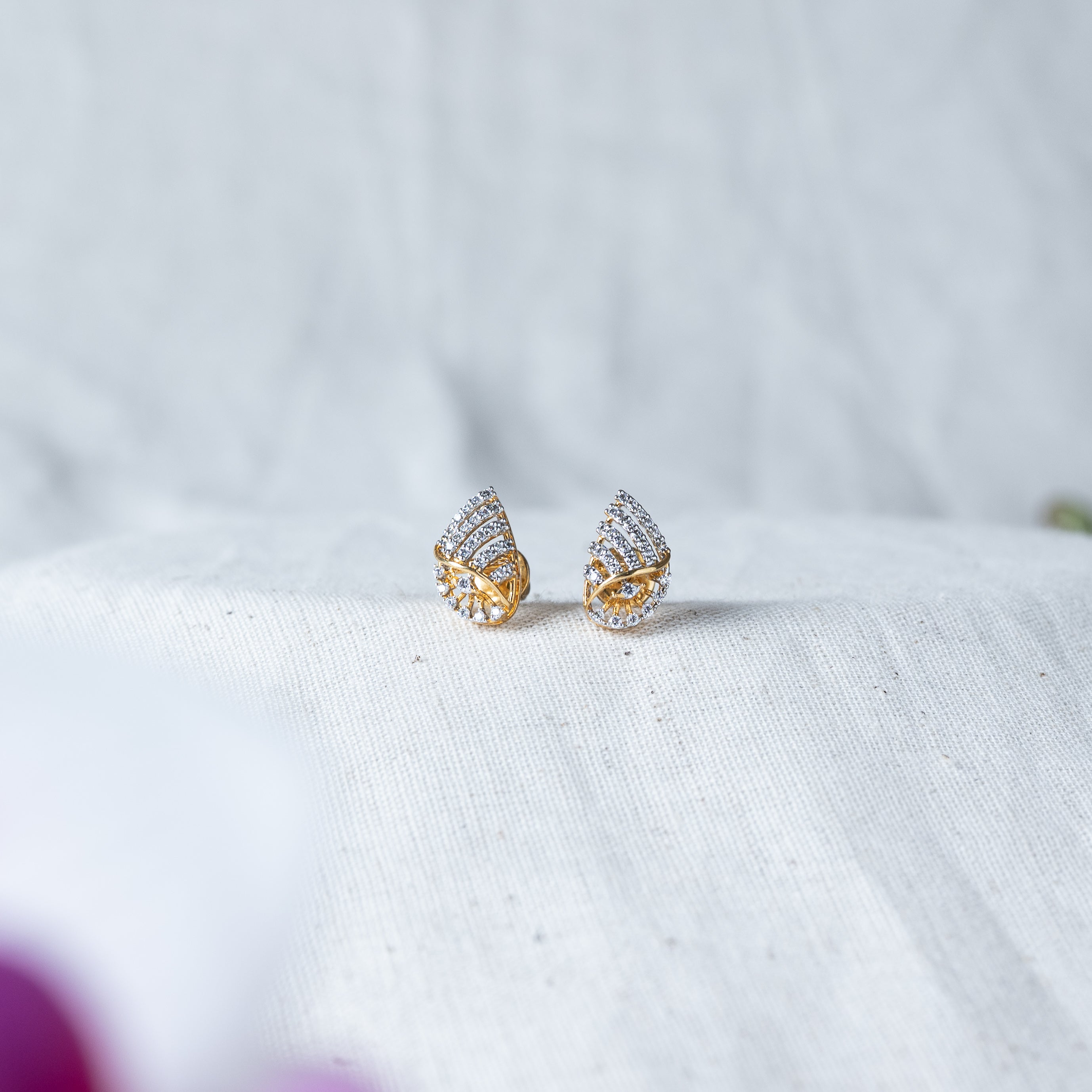 Close crop of the studs with screw post and back, CZ paved twist front in 925 silver