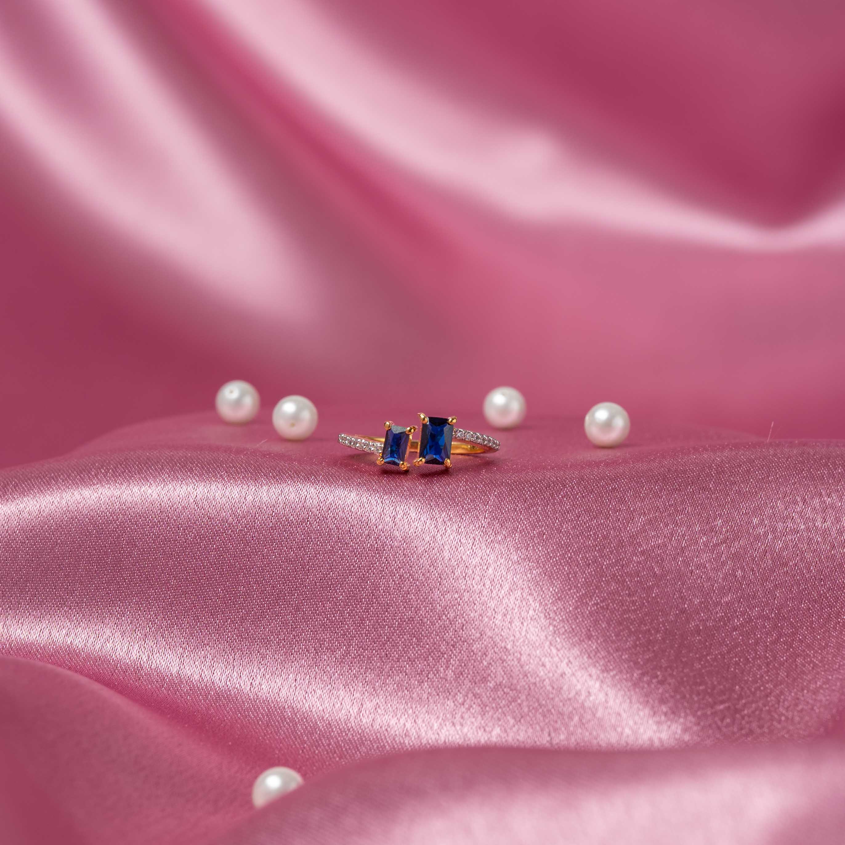 Tejas CZ ring in 925 sterling silver with gold plating featuring blue sapphire stones and sparkling CZ accents