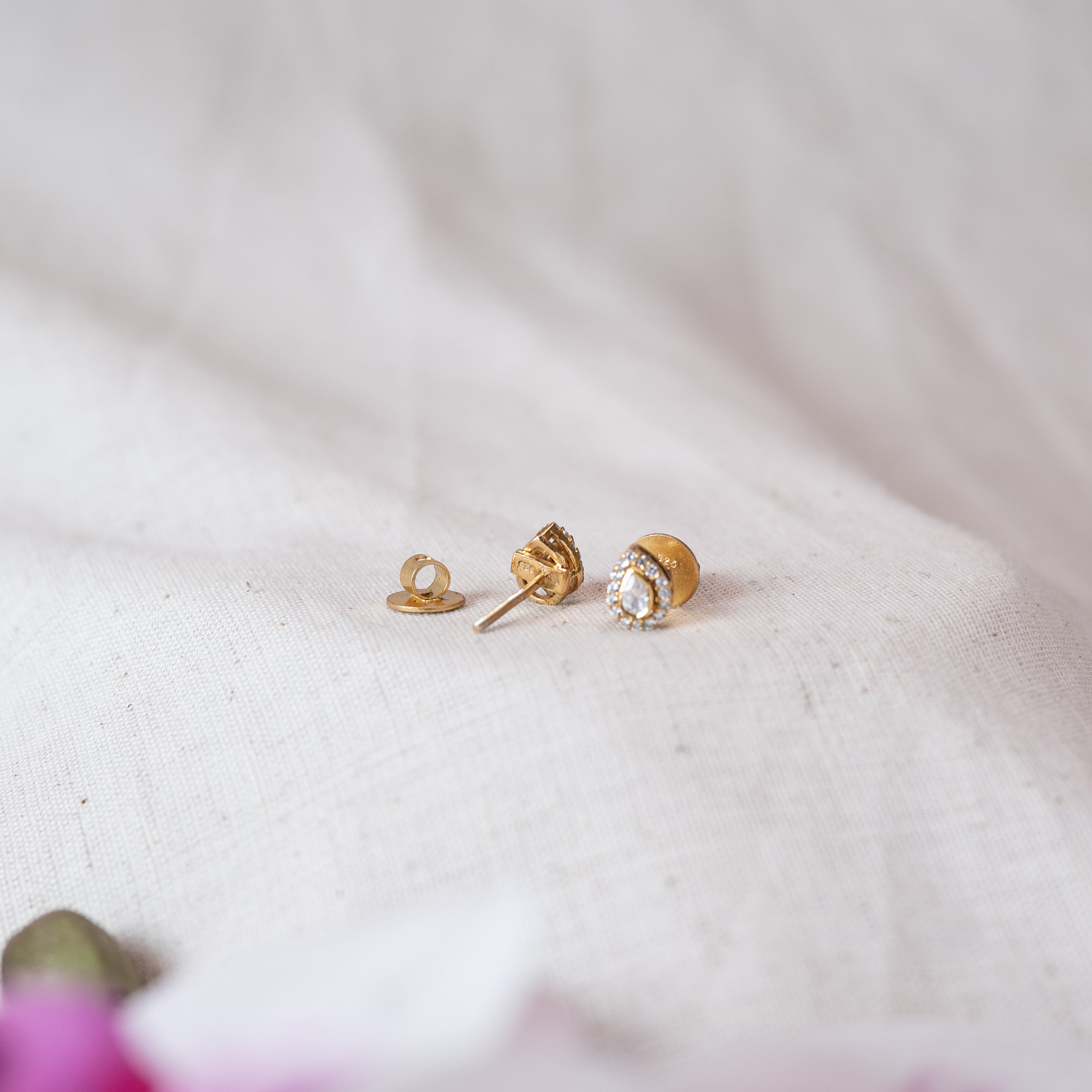 Stud post and screw back disc detached beside the polki teardrop stud face, gold plated 925 silver