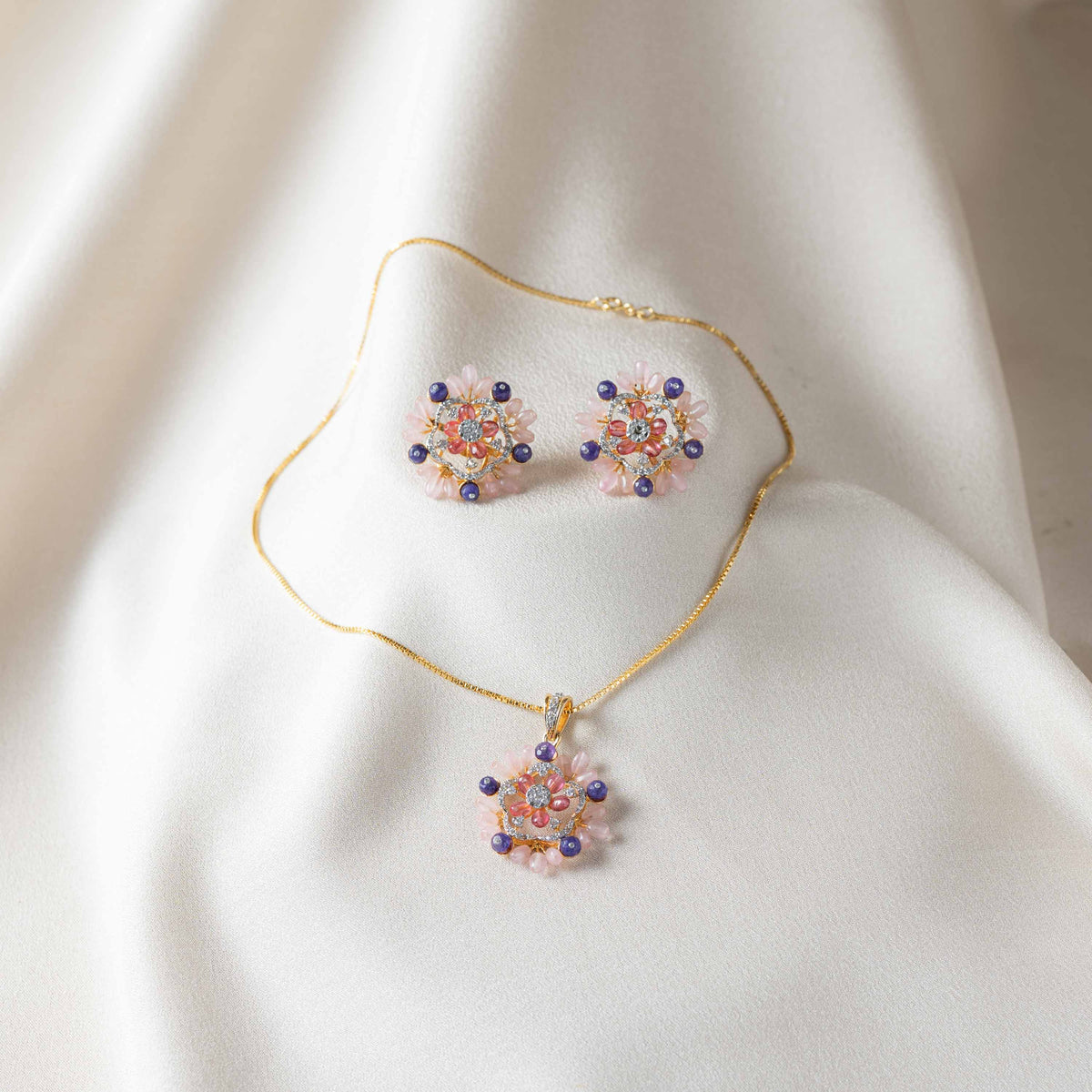 Close view of the push back post behind a pink floral stud in gold plated 925 silver