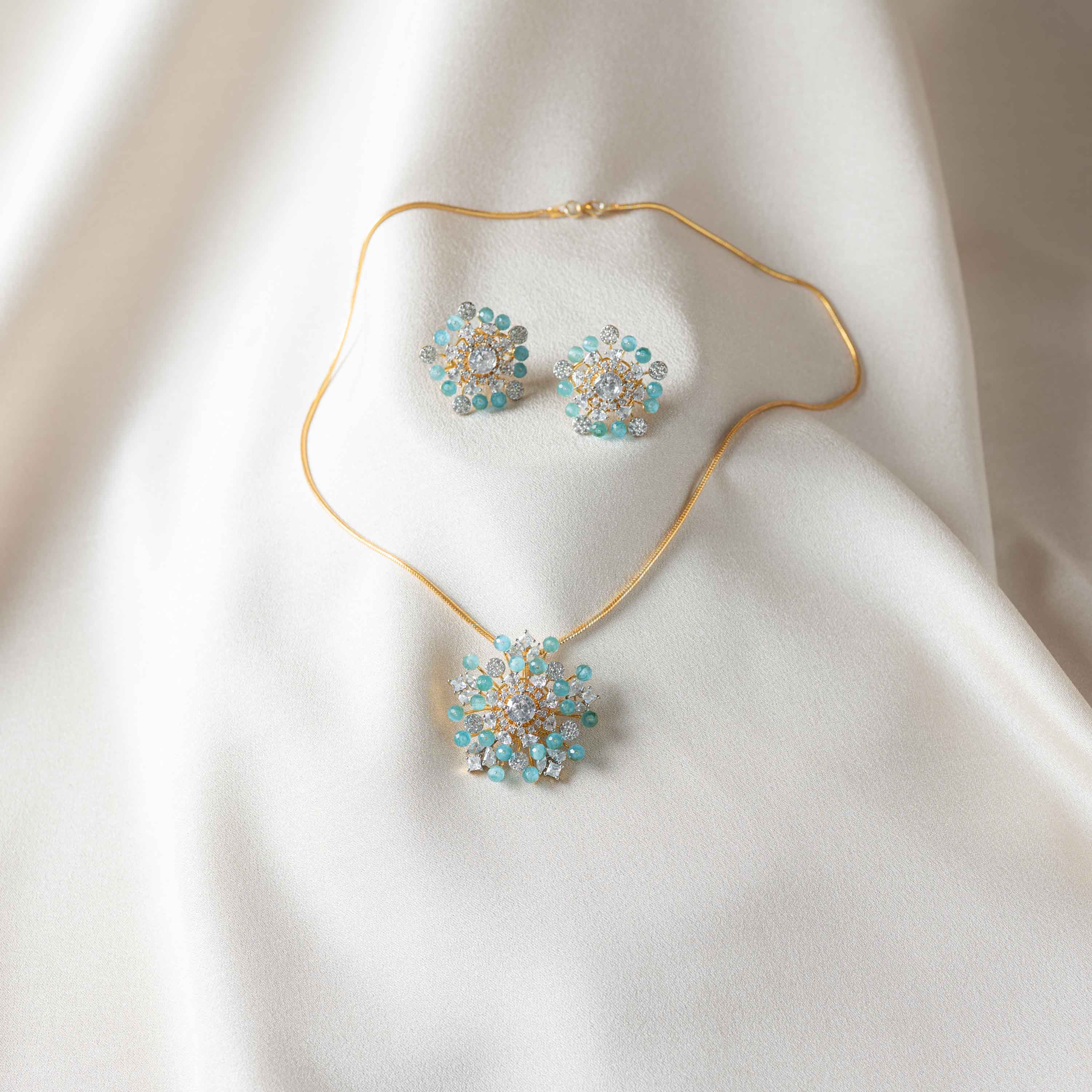 Siya CZ floral earrings with matching necklace in 925 sterling silver featuring gold plating, CZ stones and blue-green beads