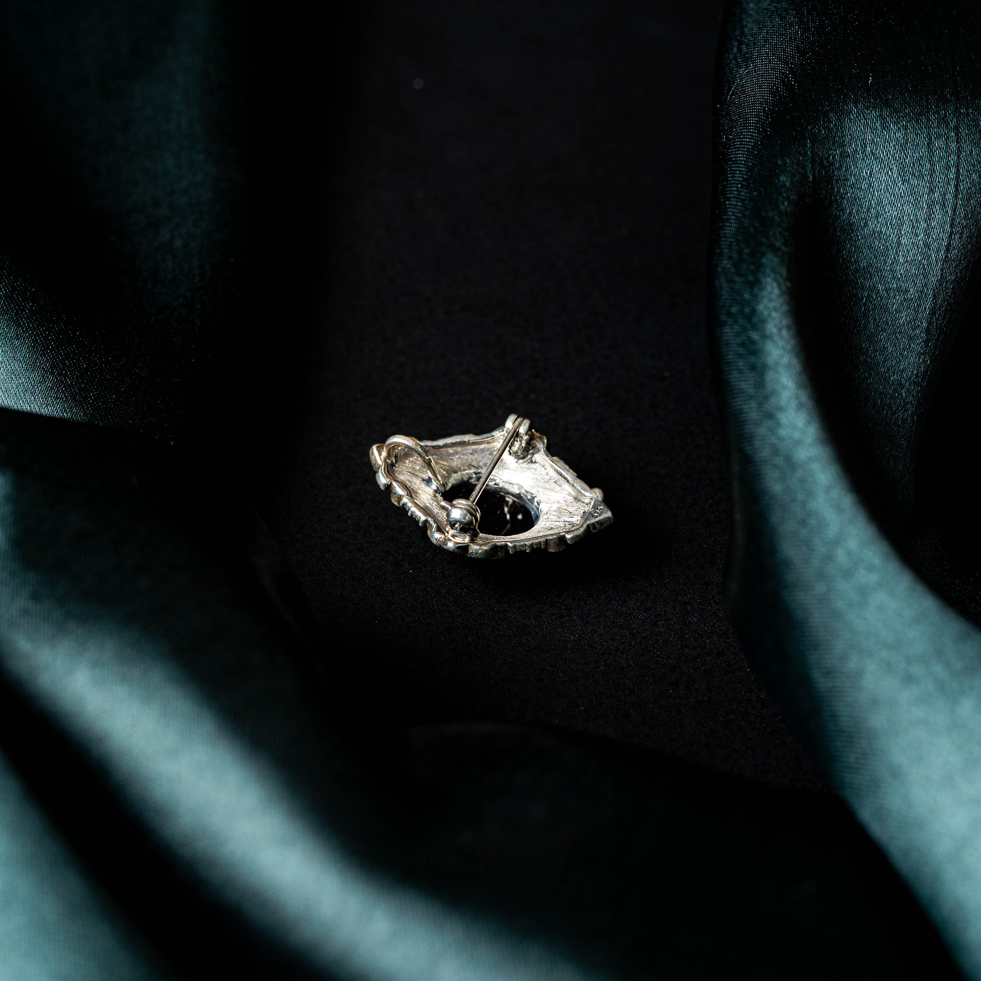 Rhombus brooch with an oval black onyx centre in a marcasite frame, oxidised 925 silver