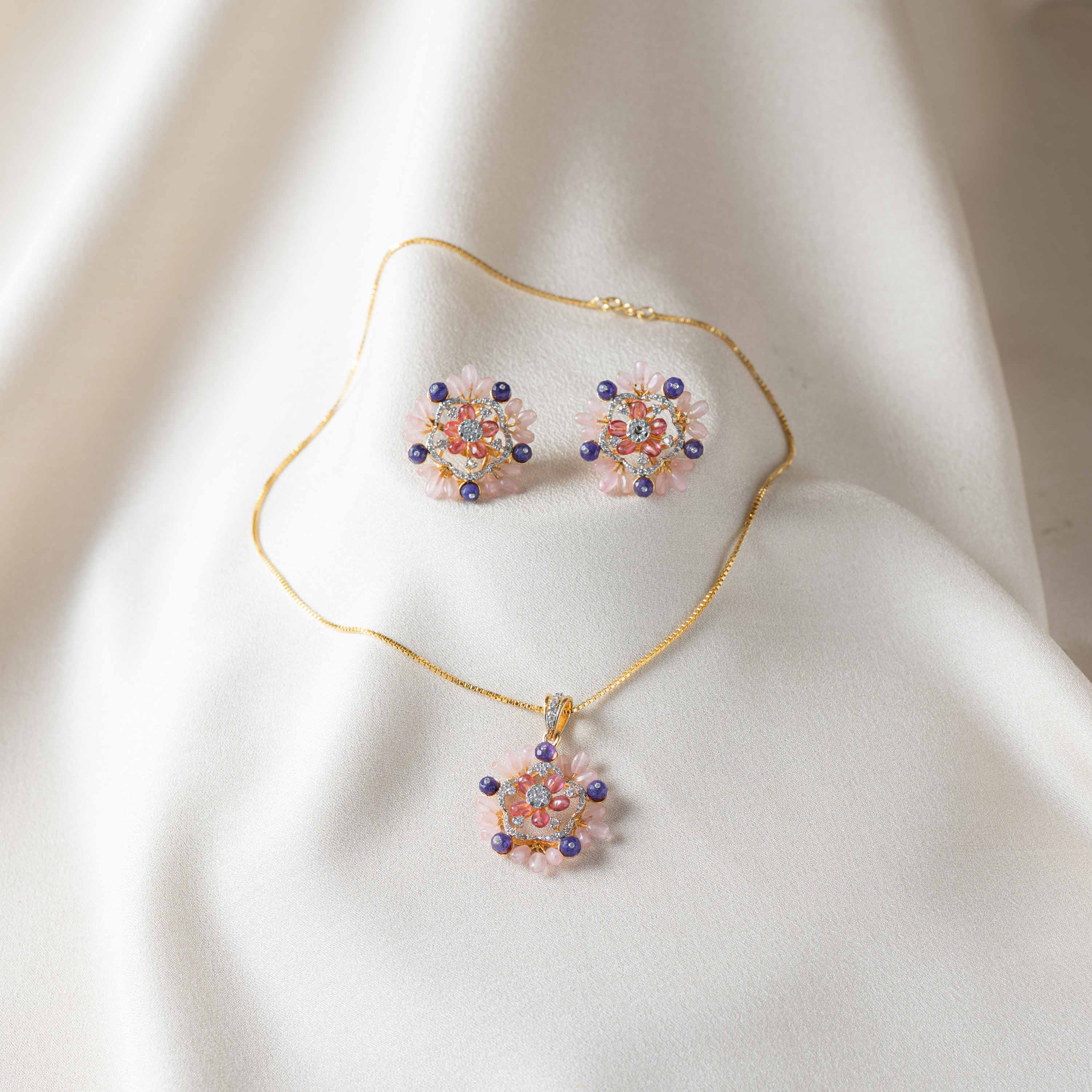 Pink floral CZ pendant in gold plated 925 silver shown hanging on a chain