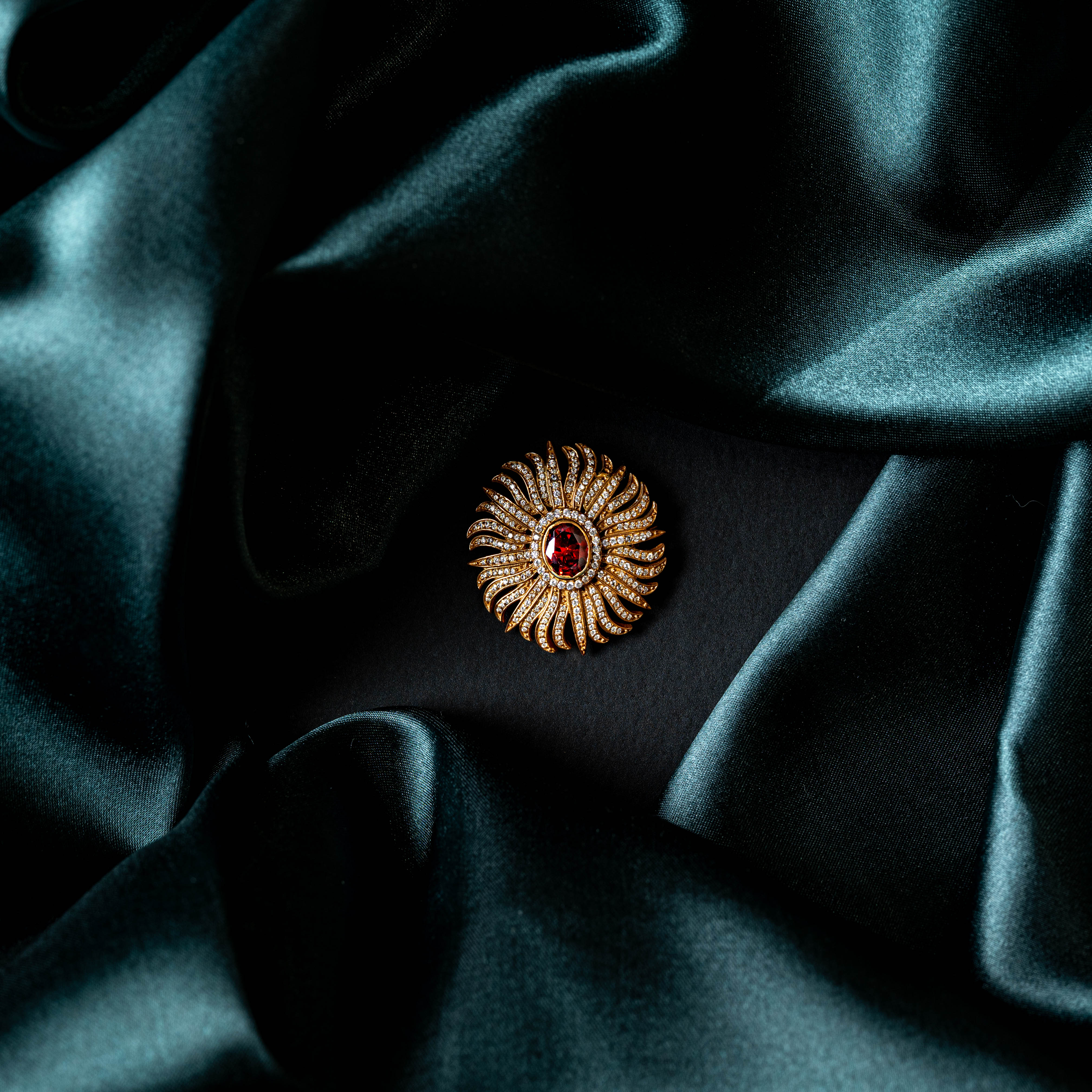 Brooch tilted to show the domed sunburst rays in profile, gold plated 925 silver