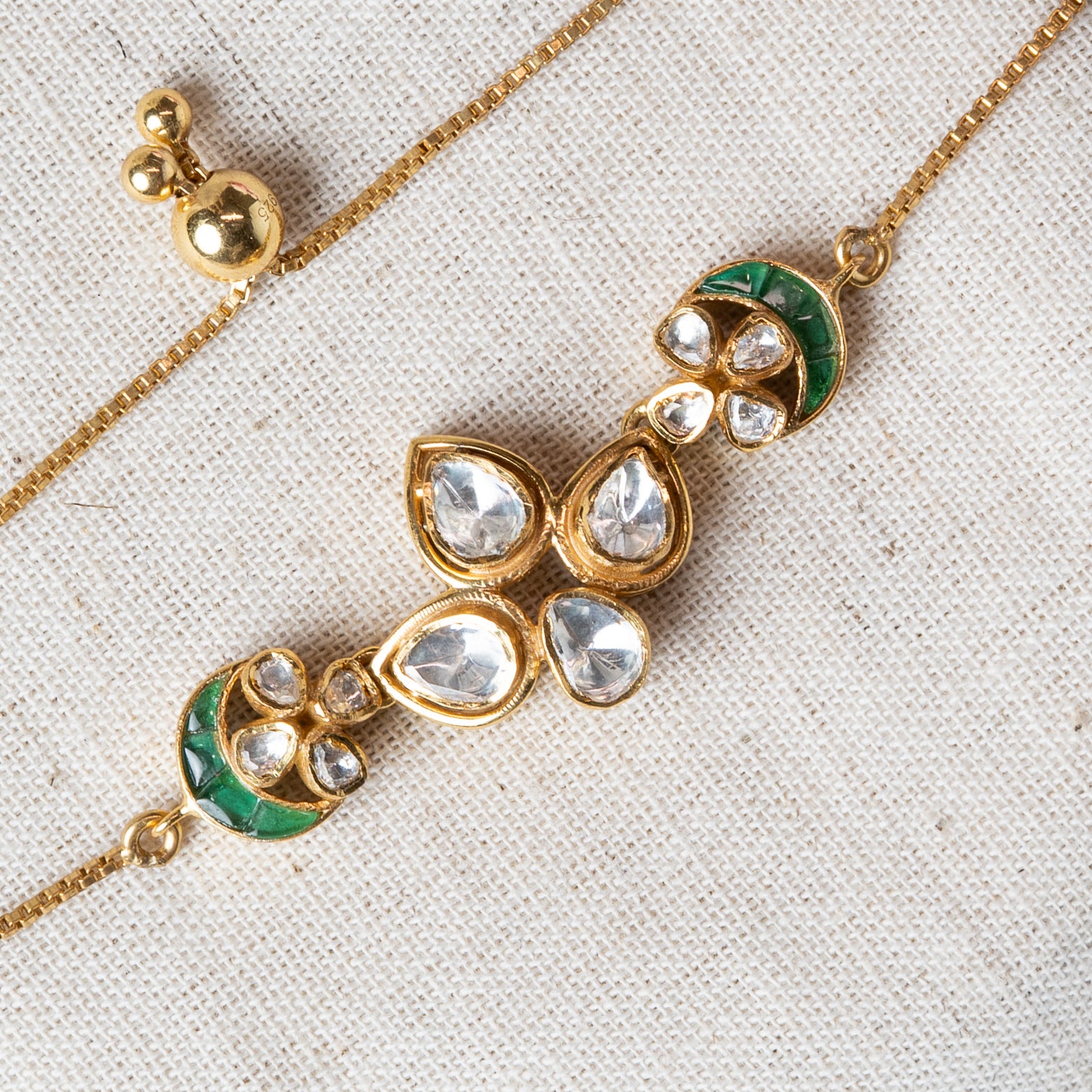 Close crop of the polki cluster and green stone crescents on the gold plated 925 silver chain
