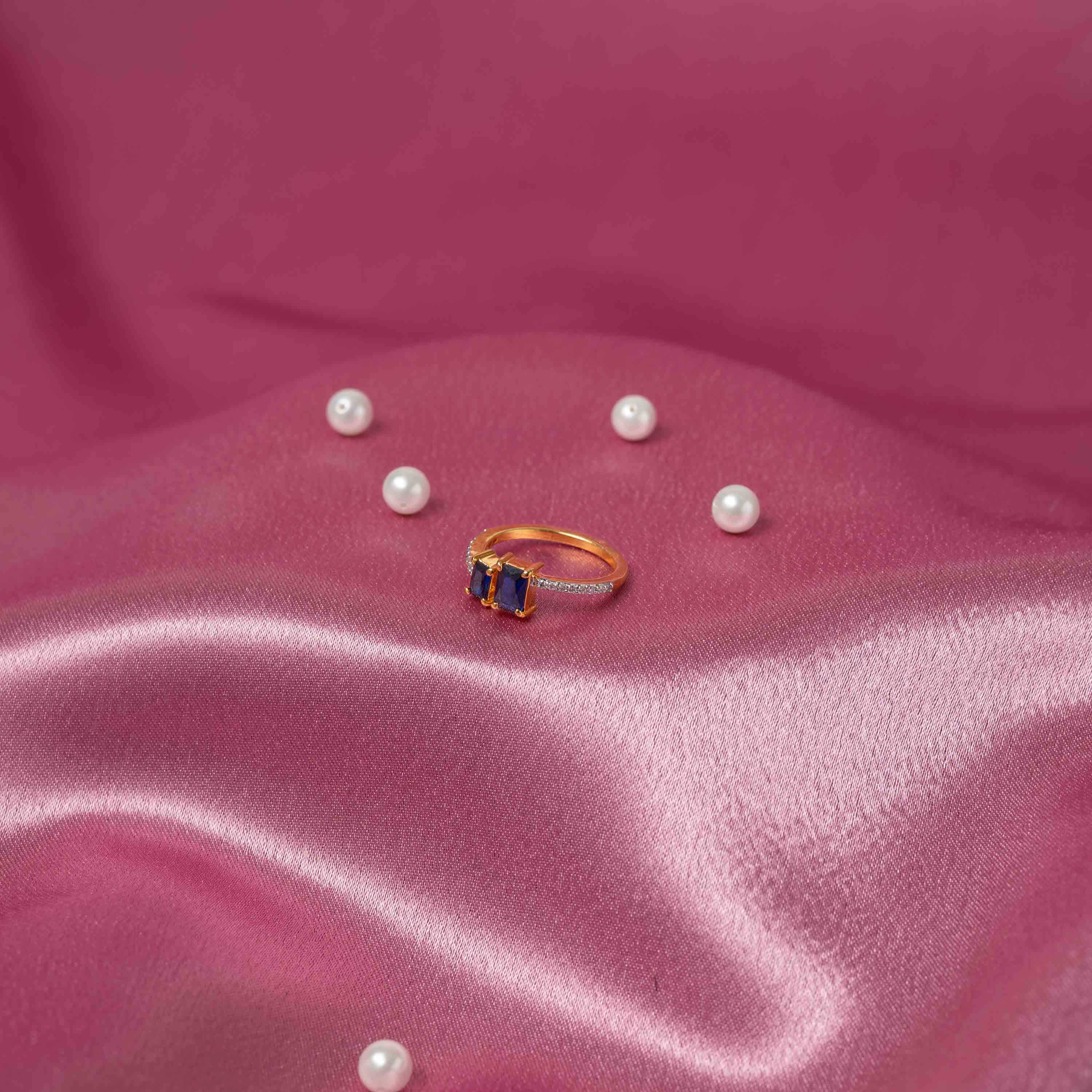 Top view of Tejas CZ ring with rectangular blue semi-precious sapphire stones and pavé CZ detailing in 925 silver