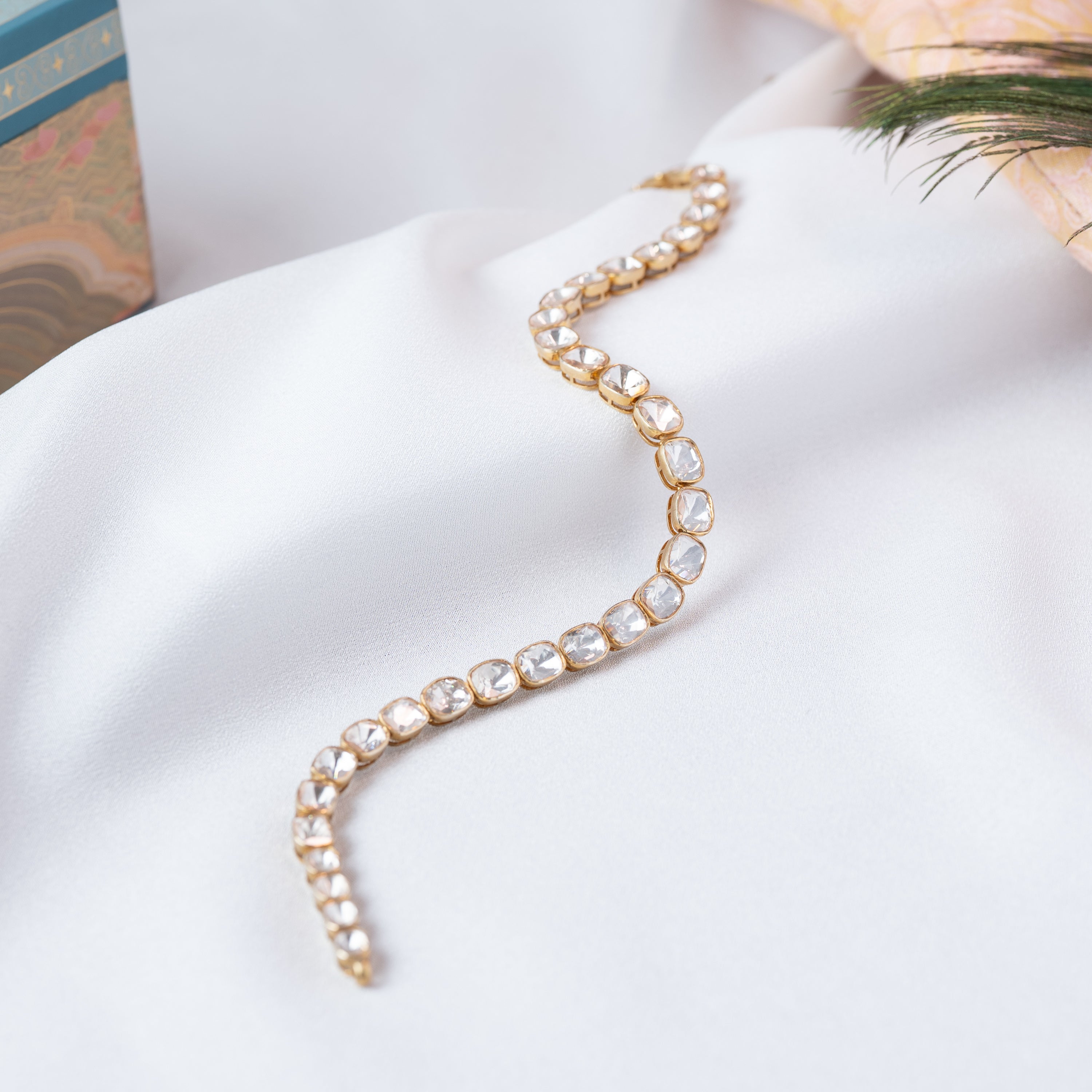 Single wavy row of cushion cut polki stones on a sherwani kantha in gold plated 925 silver, close crop