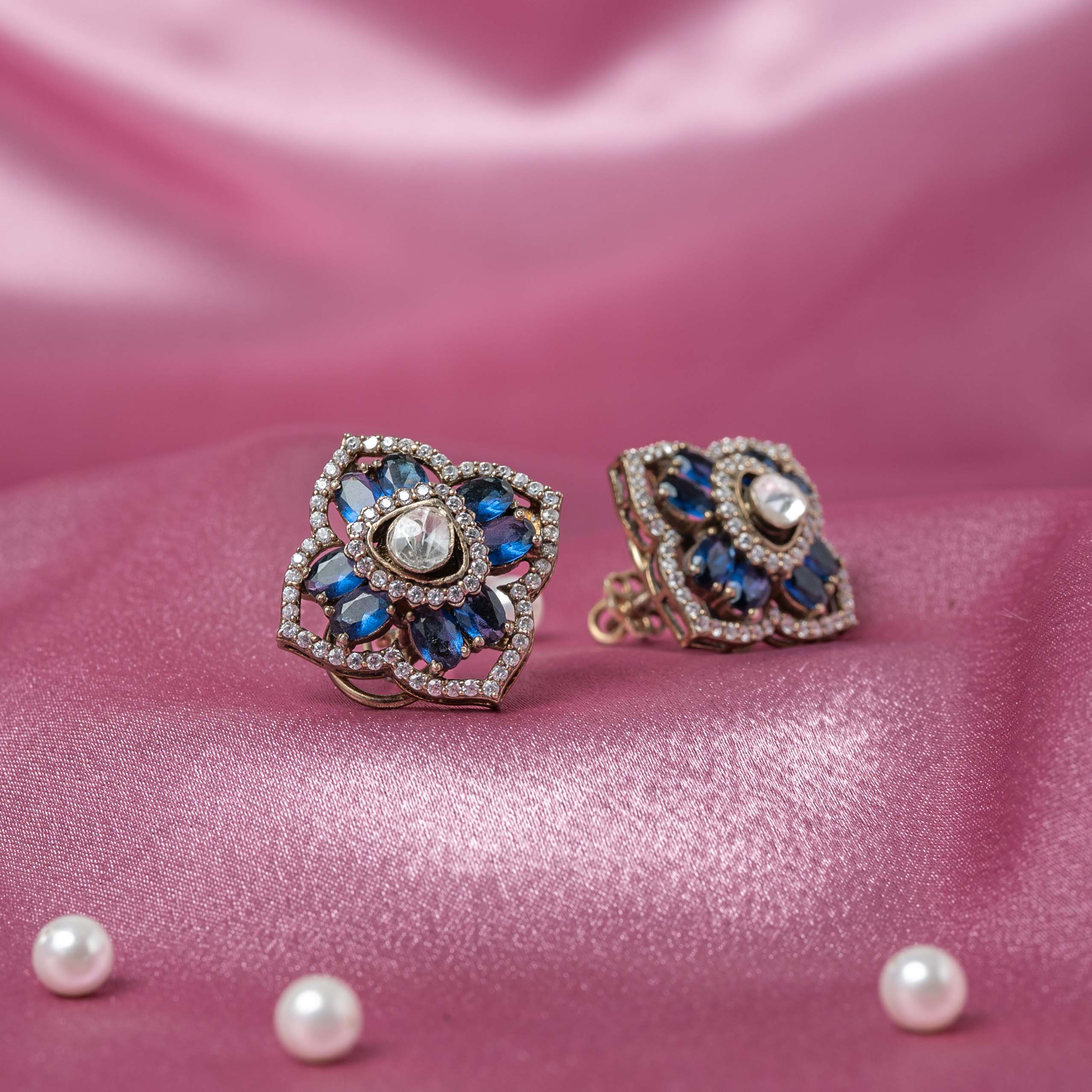Ishya Victorian stud earrings in 925 sterling silver with antique gold plating, blue sapphire stones, Moissanite Polki and CZ halo