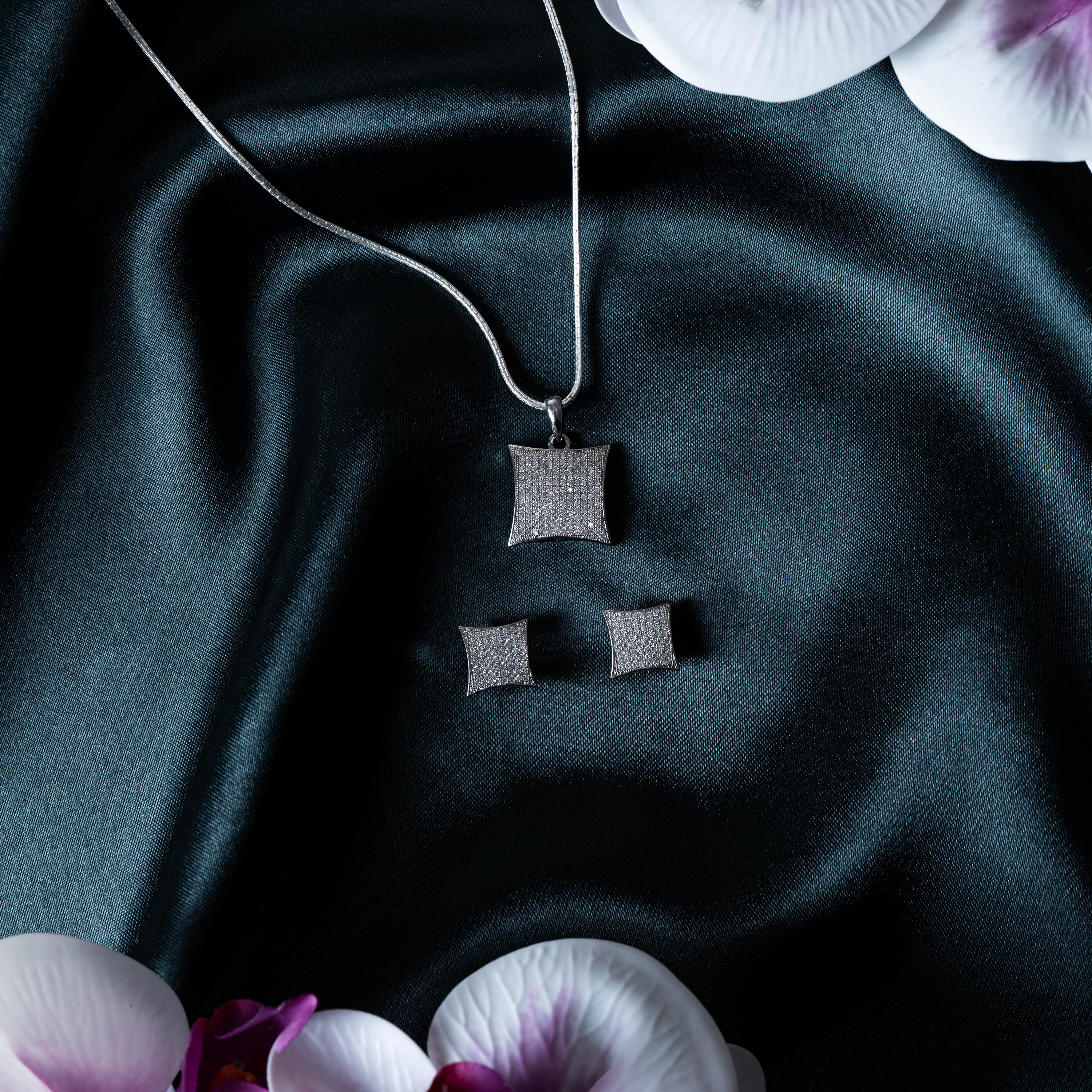 Pendant and matching kite studs laid together, CZ pave in rhodium finish 925 silver