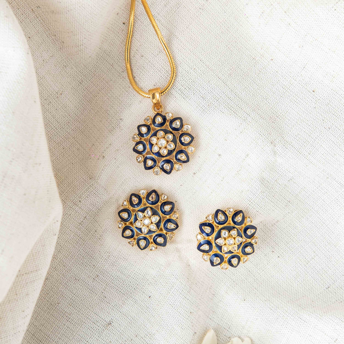Bombay screw backs behind the navy meenakari and polki studs in gold plated 925 silver