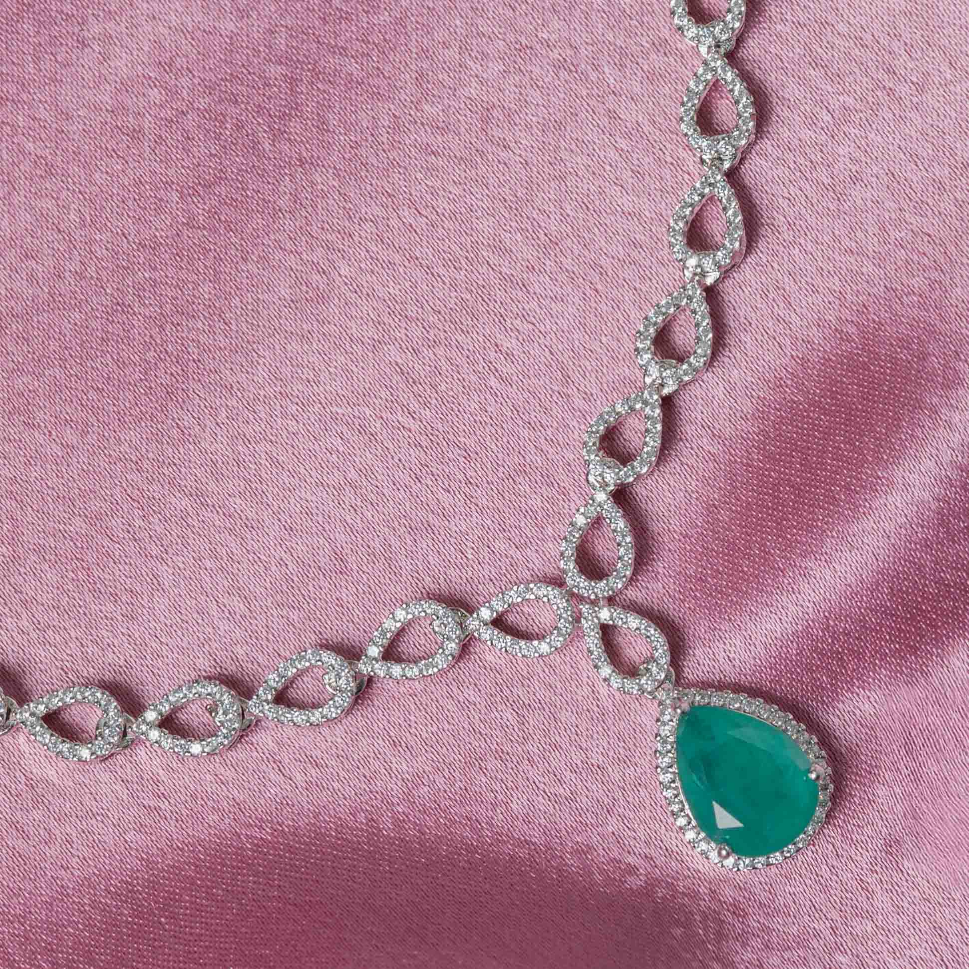 Close-up of Jivika CZ necklace in 925 sterling silver with gold plating featuring green onyx teardrop pendant and sparkling CZ stones