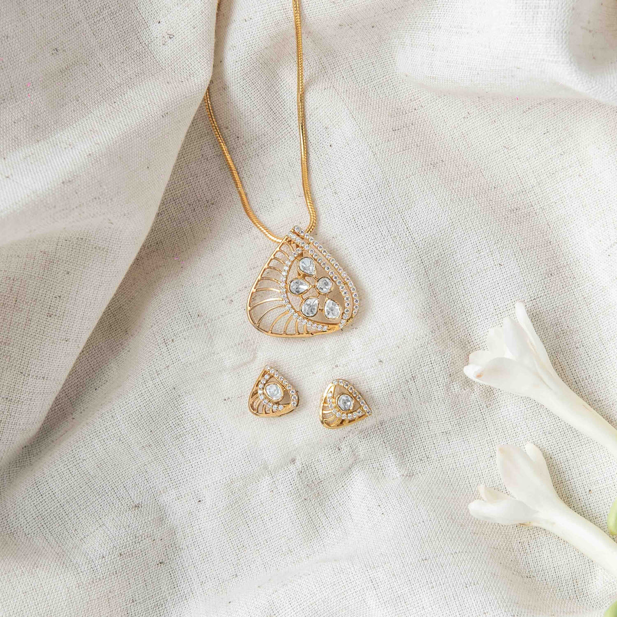 Screw back fittings behind the triangular paisley polki studs in Victorian finish 925 silver