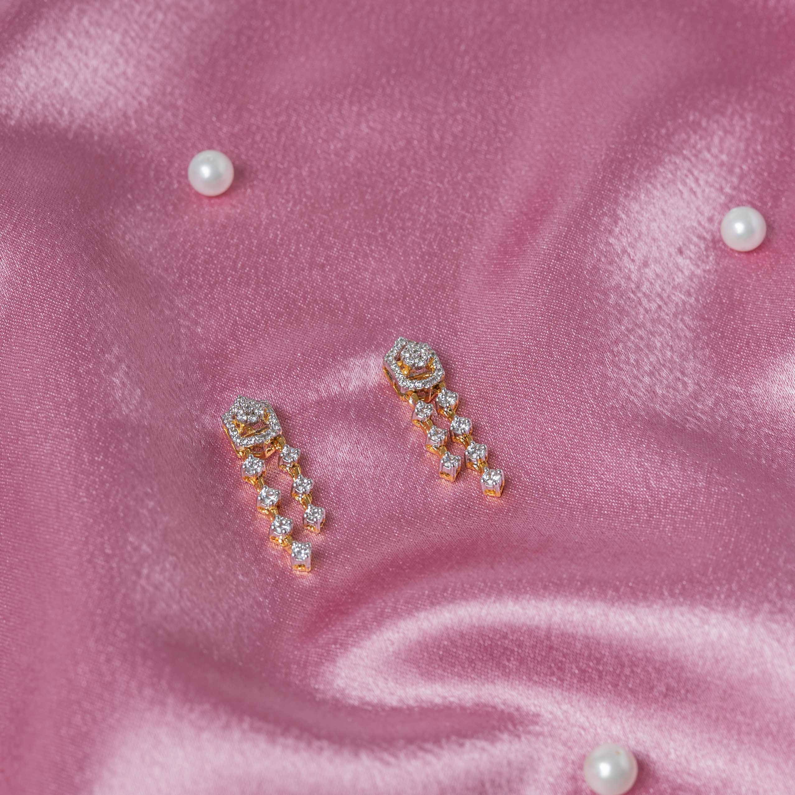 Angled close view of the pair of hexagonal CZ studs with their triple paved drops