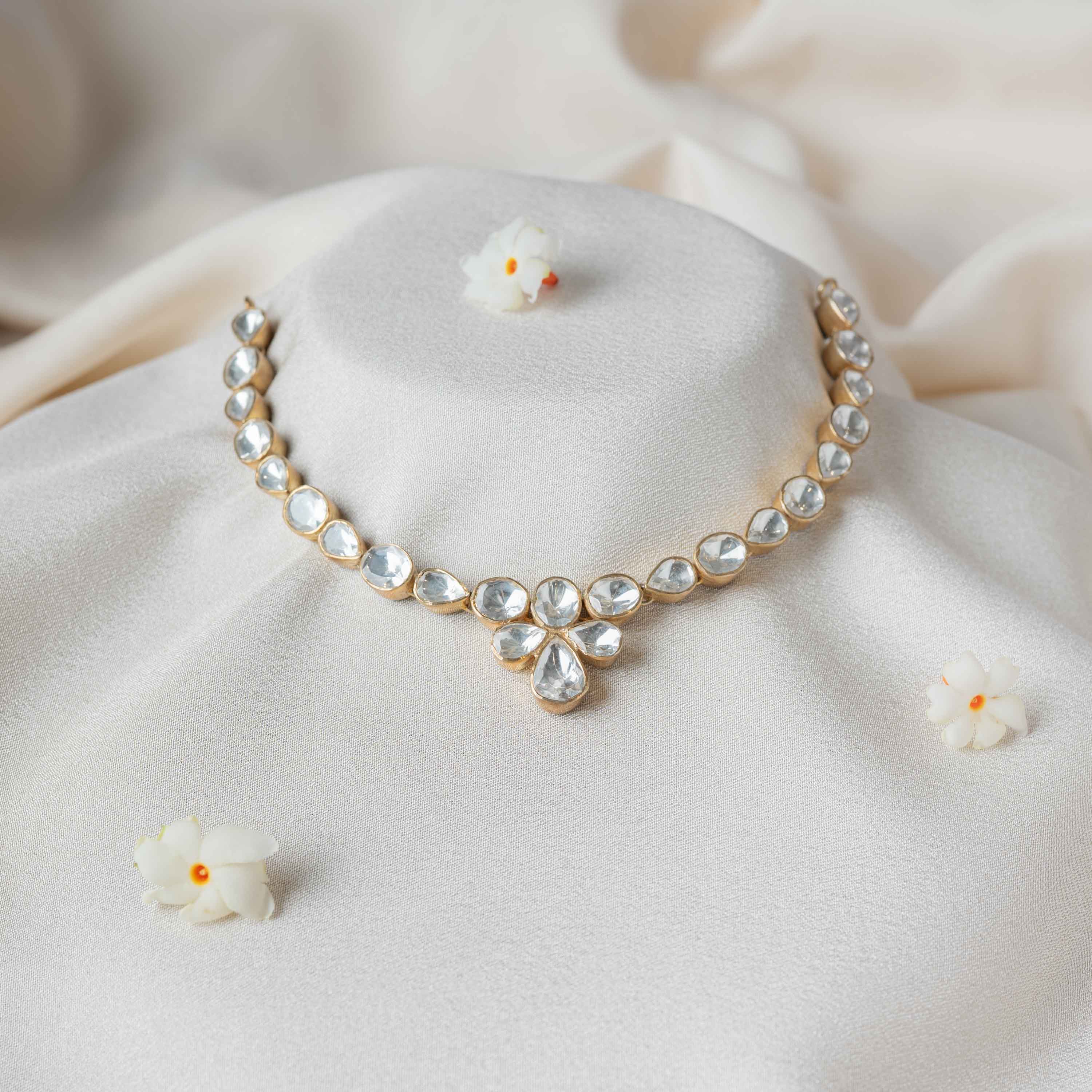 Aarna Polki Necklace in 925 sterling silver with gold plating featuring bezel-set Moissanite Polki stones and a floral pendant for wedding and festive wear.